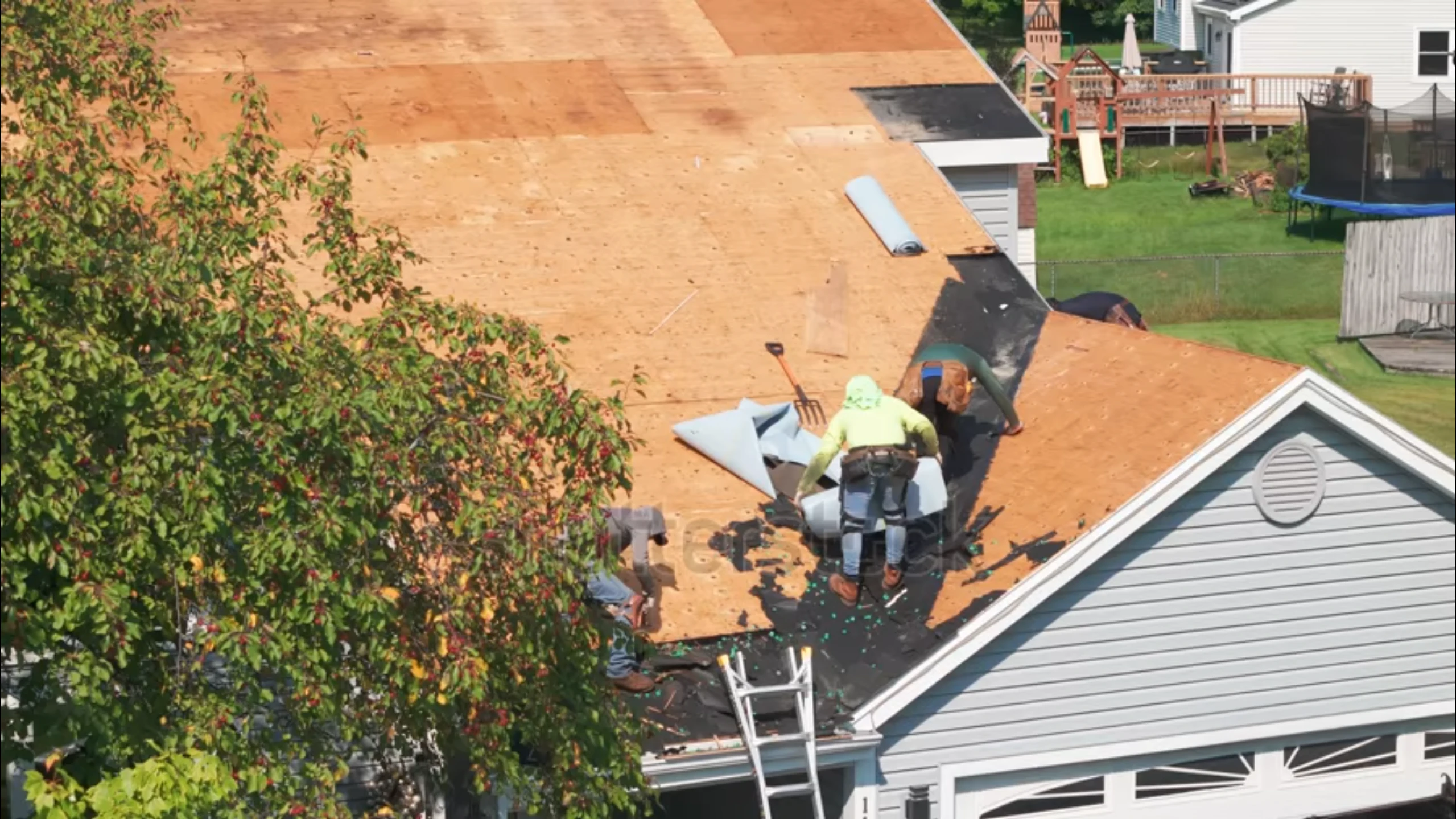 Employees Working On Roof